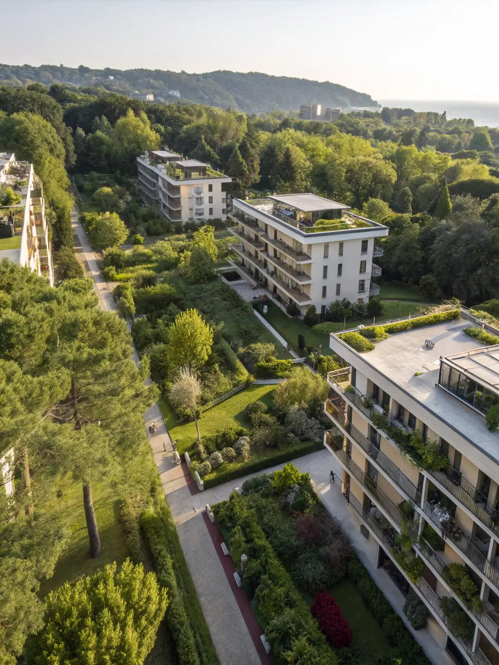 An aerial view of a modern multifamily residential complex, representing multifamily financing options, with lush landscaping and community amenities.