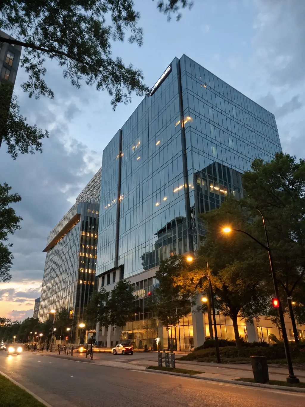 A professional photograph of a modern hotel exterior at sunset, symbolizing expertise in hotel financing.